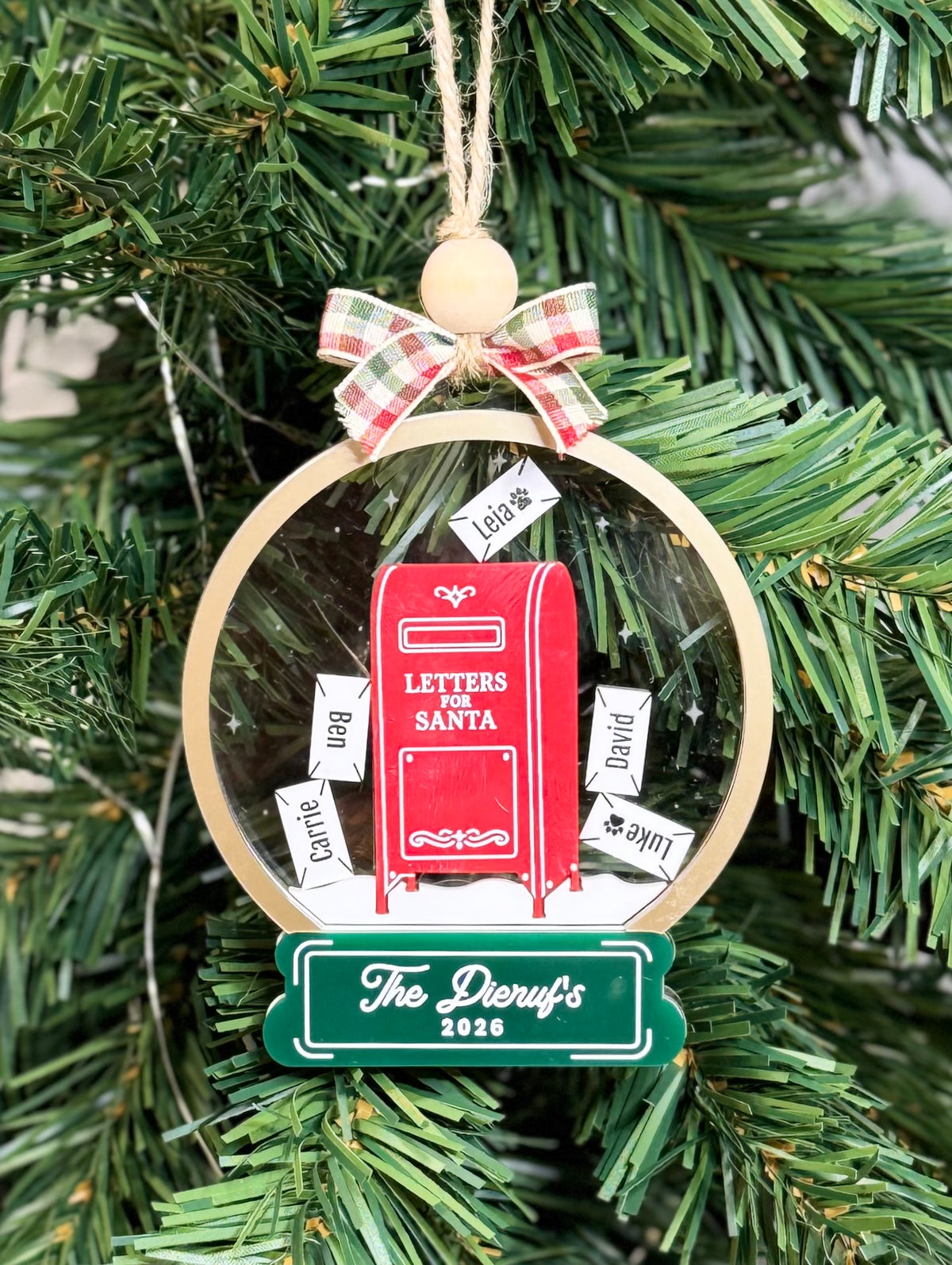 Personalized Letters to Santa shaker ornament with red mailbox and family name envelopes hanging on a Christmas tree