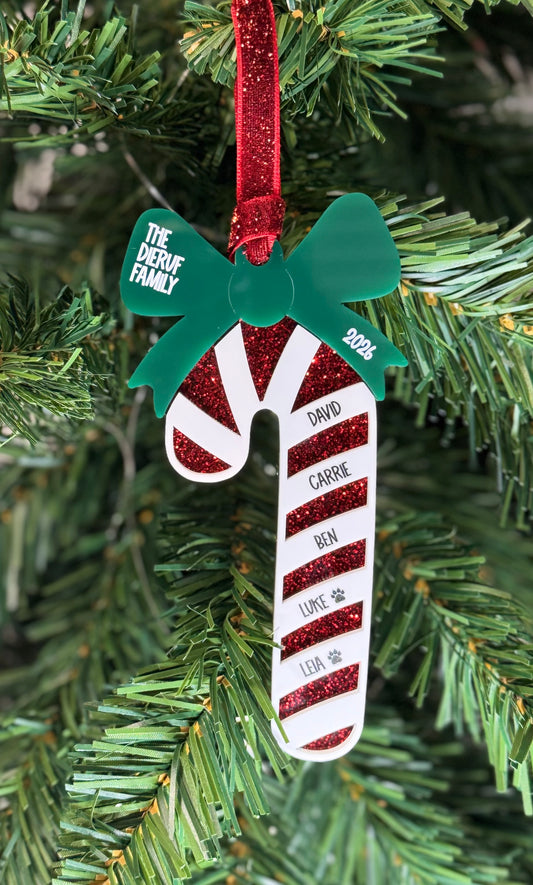Personalized candy cane family Christmas ornament with red glitter stripes, green bow, and family names